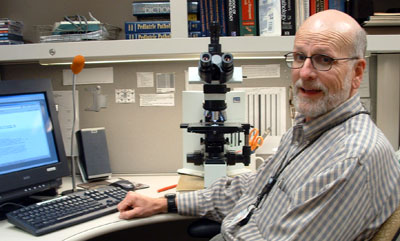 picture of chris hall at desk at work