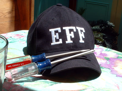 an EFF hat next to philips head and standard head screwdrivers