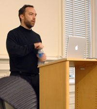 Image of Jimmy Wales at the podium speaking at SIMS