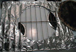 a picture of oven baffling... that is, an oven rack, covered with foil and a hole cut out for a circular baking stone